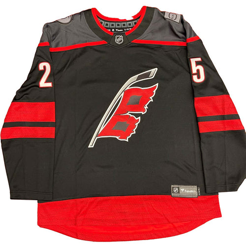 Front view of black  Carolina Hurricanes Ethan Bear Cree Syllabics jersey signed on jersey number
