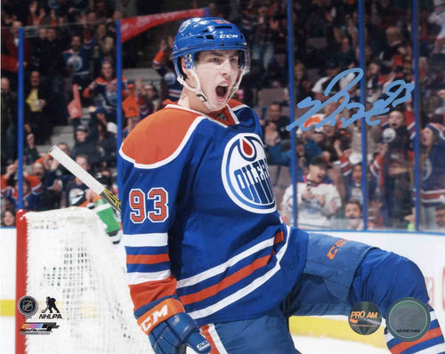 Signed photo of Ryan Nugent-Hopkins celebrating during an Edmonton Oilers home game, wearing bright blue and orange jersey. 