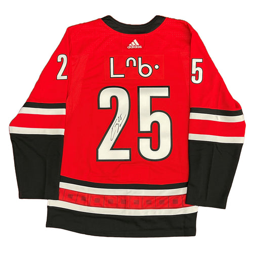 Back view of red Carolina Hurricanes Ethan Bear cree syllabics jersey signed on jersey numbers
