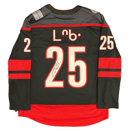 Back view of black  Carolina Hurricanes Ethan Bear Cree Syllabics jersey signed on jersey number