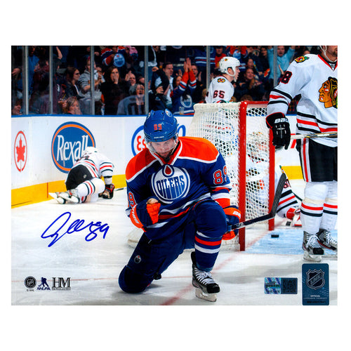 Signed photo of Sam Gagner kneeling in celebration during his  8 point game with the Edmonton Oilers vs the Chicago Blackhawks. Photo is signed in the lower left corner