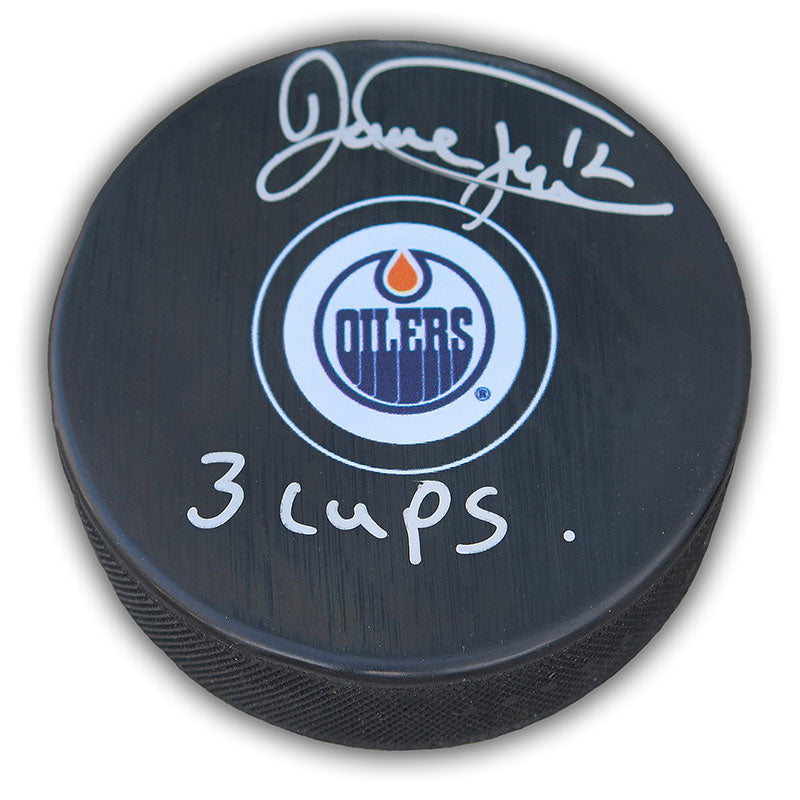 Signed black hockey puck with Edmonton Oilers logo and Dave Hunter autograph and "3 cups" inscription in silver