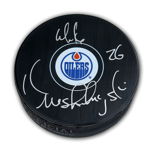 Black NHL hockey puck with Edmonton Oilers logo, puck is signed by Mike Krushelnyski