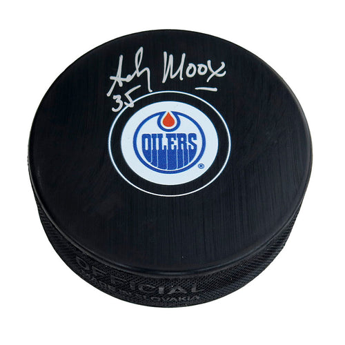 Black hockey puck with Edmonton Oilers logo in middle of the front. Signed by Andy Moog. 