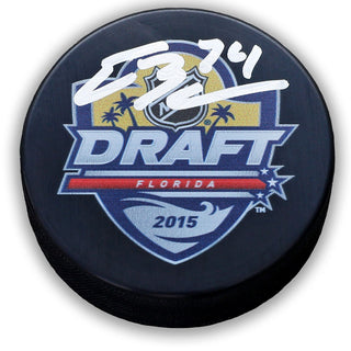 Black NHL hockey puck with 2015 NHL Florida Draft design. Puck is signed by Ethan Bear in white ink. 