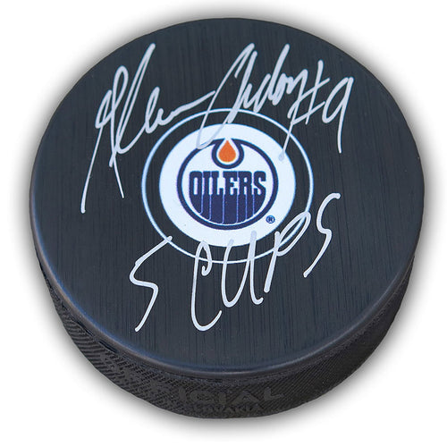 Black NHL hockey puck with Edmonton Oilers logo, puck is signed by Glenn Anderson with "5 Cups" inscription