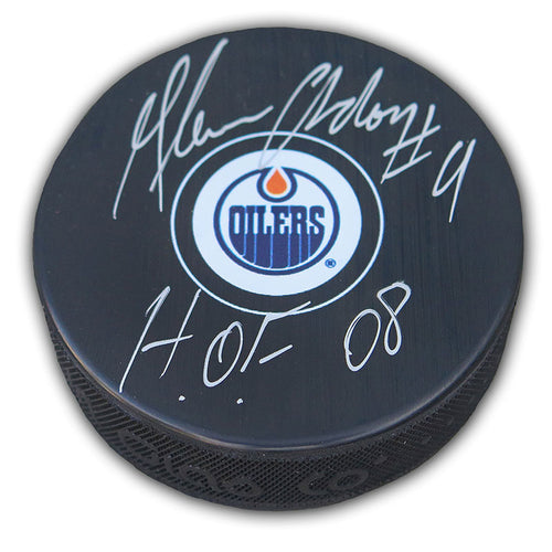 Black NHL hockey puck with Edmonton Oilers logo; puck is signed by Glenn Anderson  with inscription " H.O.F. 08"