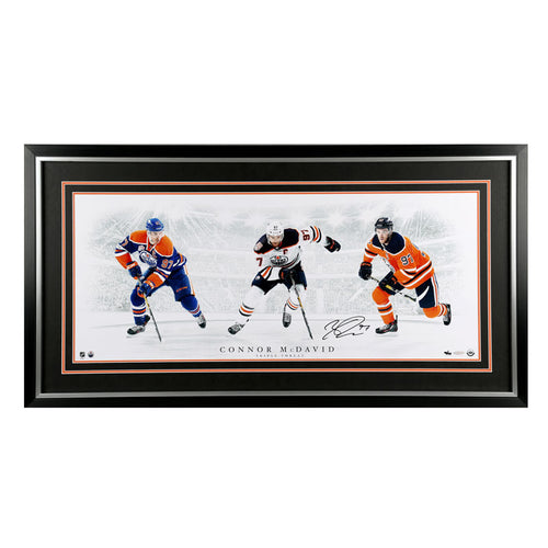 Framed signed image of Connor McDavid in three different Edmonton Oilers NHL game jerseys, framed in black with black and orange mats
