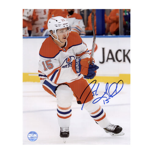 Photo of Edmonton Oilers Josh Archibald skating during an Oilers NHL hockey game, he is wearing white jersey. Photo is signed in blue ink in the lower right. 