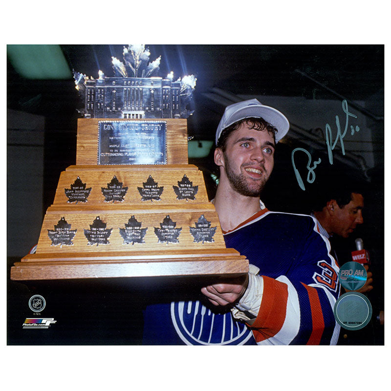 Signed photo of Bill Ranford of the Edmonton Oilers holding the 1990 Conn Smythe trophy 