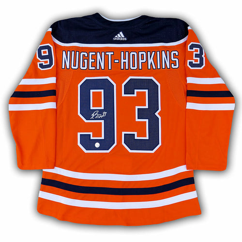 Back view of Ryan Nugent-Hopkins signed Edmonton Oilers orange home jersey. Jersey is signed on the number 9. 
