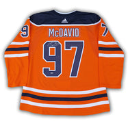 Back view of an autographed Connor McDavid orange Edmonton Oilers NHL home game jersey