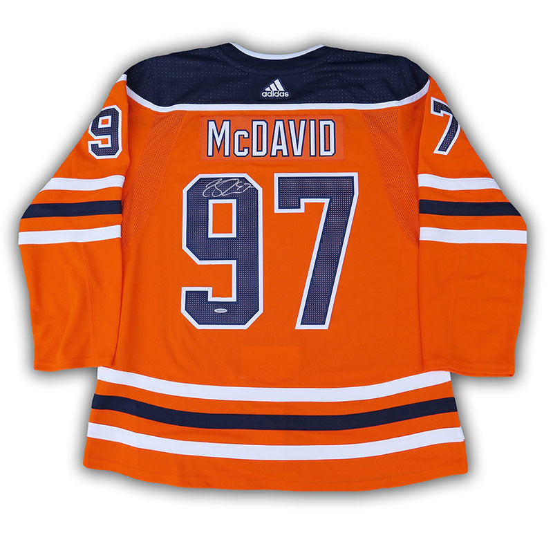 Back view of an autographed Connor McDavid orange Edmonton Oilers NHL home game jersey