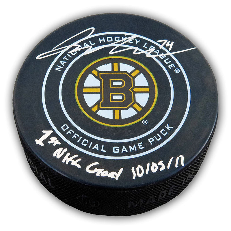Black NHL Boston Bruins official game puck singed by Jake DeBrusk with inscription "1st NHL Goal 10/05/17" 