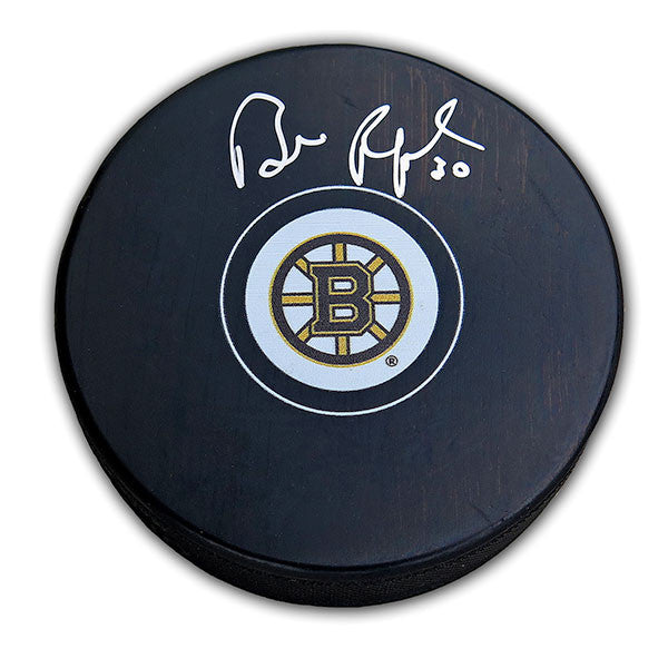 Black puck with Boston Bruins logo signed in silver by Bill Ranford