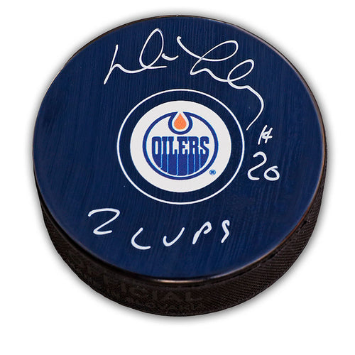 Black hockey puck with Edmonton Oilers with autograph and "2 Cups" inscription from Dave Lumley in silver ink