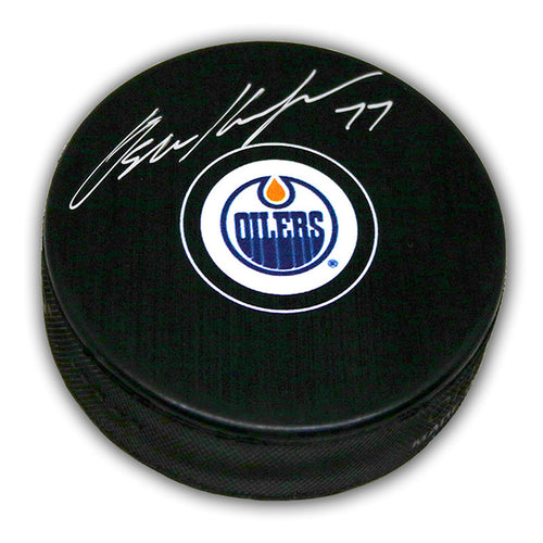 Black NHL hockey puck with Edmonton Oilers logo, signed by Oscar Klefbom. 