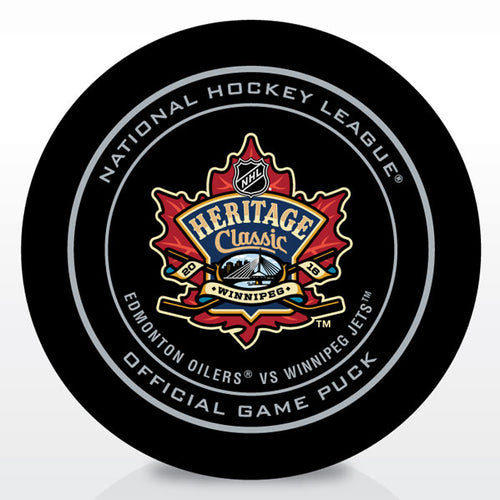 Front view of black hockey puck with NHL official game puck design and 2018 Winnipeg Heritage Classic logo featuring the Winnipeg Jets and Edmonton Oilers